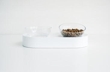 White bowl for dog or cat with feed and water isolated on white background.