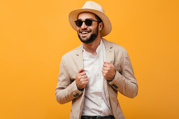 Man in good humor laughing on orange background