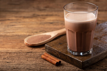 Glass with chocolate on the table.