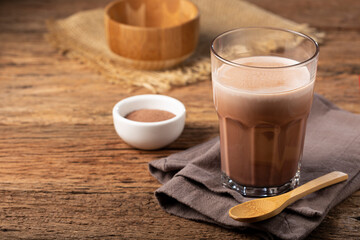 Glass with chocolate on the table.