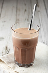 Glass with chocolate on the table.