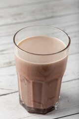 Glass with chocolate on the table.