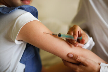 nurse in mask and white coat injects child girl with syringe, calling doctor at home, patronage. Treatment of pediatrician at home in real interior, the concept of medicine and disease prevention