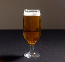 Beer glass isolated on a bright yellow background. 