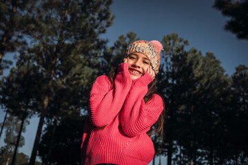 Little girl in cold weather wearing hat outdoors.