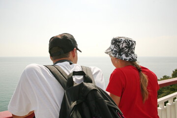 Fototapeta premium young people look into the distance at the sea
