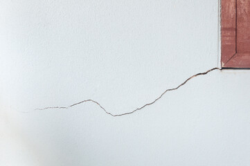 Wall of the houses cracked near the window frame.