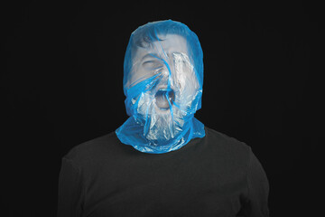 Blue garbage bag on man head. Exit bag for suicide.
