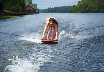  Young woman On Wakeboard. Awesome summer water sport and resting. Wakeboarding.