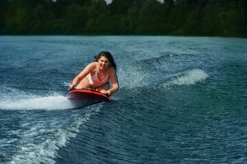  Young woman On Wakeboard. Awesome summer water sport and resting. Wakeboarding.