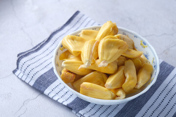 top view of slice of jackfruits in a bowl on table.