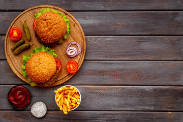 Homemade burgers with pickles and fries. Top view