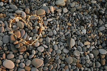 glowing heart on a background of sea pebbles