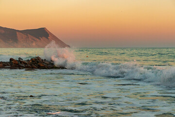 Dark blue waves against the beautiful orange sunset at the Black Sea, Anapa, Russia