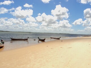 Fototapeta na wymiar View of a beautiful deserted beach with small wooden boats - Maceió - Brazil.
