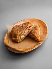 Delicious ciabatta with chicken on a wooden tray