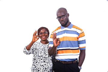 portrait of a young couple showing okay gesture, smiling.
