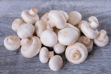 a bunch of champignons lie on a wooden board