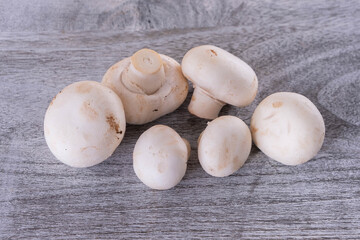 a bunch of champignons lie on a wooden board