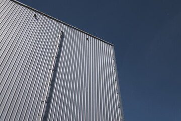 Fototapeta na wymiar Corrugated structure soars into blue sky