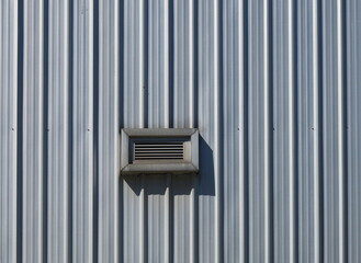 Isolated ventilation grille on corrugated facade
