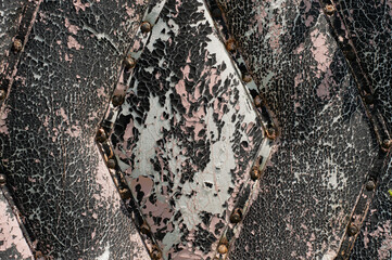 Fragment of an old door, covered with a fabric with cracked paint in different colors. Abstract, vintage background.vintage background.