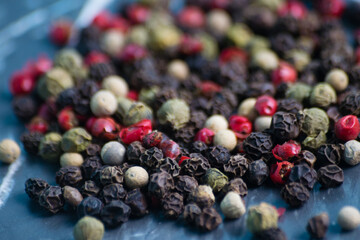 Mix of peppers peas on a dark background, close-up with blurred background and foreground, copy space