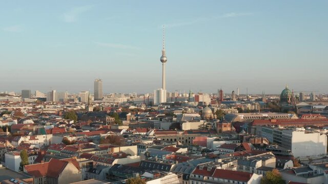 Sunny afternoon panoramic aerial view of city with TV lookout tower landmark. Slow movement forwards. Berlin, Germany.