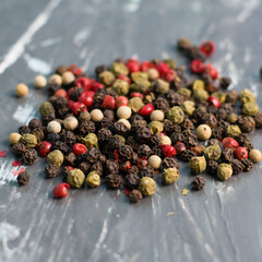 Mix of peppers peas on a dark background, close-up with blurred background and foreground, copy space
