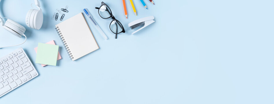 Online learning design concept. Top view of student table with computer, headphone and stationeries.