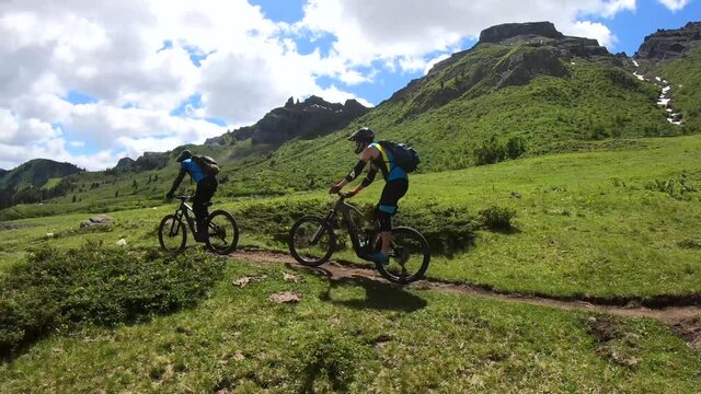 Mountain Bikers Riding the All Fever Trail on the Sellaronda MTB Route, Dolomites, Italy