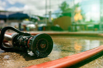 Water jet splashing from a fire fighting firehose nozzle