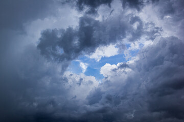 The dark sky had clouds gathered to the right and a strong storm before it rained.Bad weather sky.