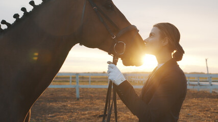 Horse owner Kissing her dark bay horse with love. Expressing her love for the Stallion. Girl...