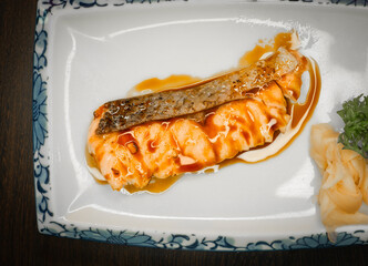 Grilled salmon topped with sweet Japanese teriyaki sauce. Ready to eat on a plate.