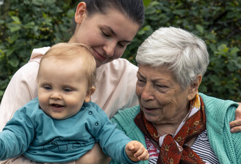 Portrait of happy family grandmother granddaughter great-grandson. 