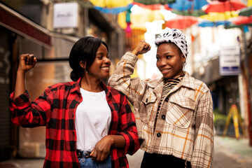 Portrait of a happy smiling female friends. Beautiful african woman laughing outdoors.