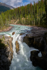 Sunwapta Falls Jasper Alberta vertical. Water pours over Sunwapta Falls. Jasper National Park. Alberta, Canada.

