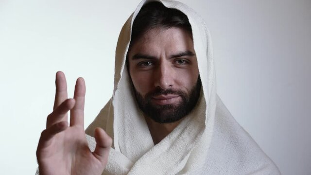 Jesus raises his hand and closing his eyes