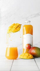 mango juice on table in glass on light tile table. mango juice splash. summer concept