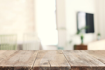 empty table board and defocused indoor background. product display concept