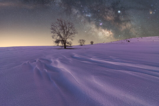 Milky Way in sky over snowy terrain