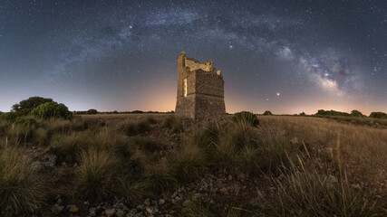 Starry sky with Milky Way above ruined tower