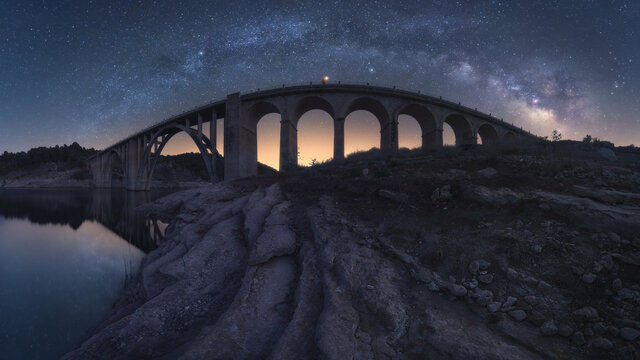 Milky Way over arched stone bridge