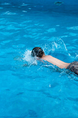 Jumping in pool, splashing water