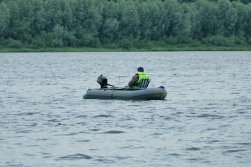 Fishing on the river. Fishermen fish from a rubber boat on the river. summer in good weather.