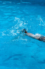 Jumping in pool, splashing water
