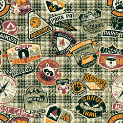 Cute mountain camp and wildlife adventure badges patchwork with grunge tartan plaid background vector seamless pattern 
