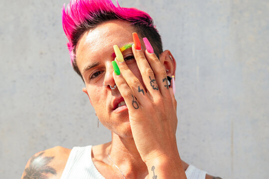Queer man with colorful nails