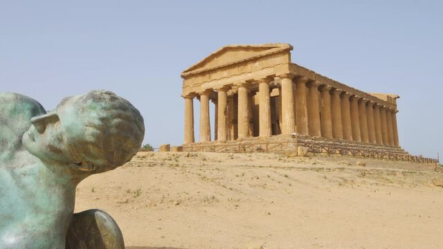 Dolly shot of the temple of concordia and icarus statue,valley of the temples agrigento sicily italy